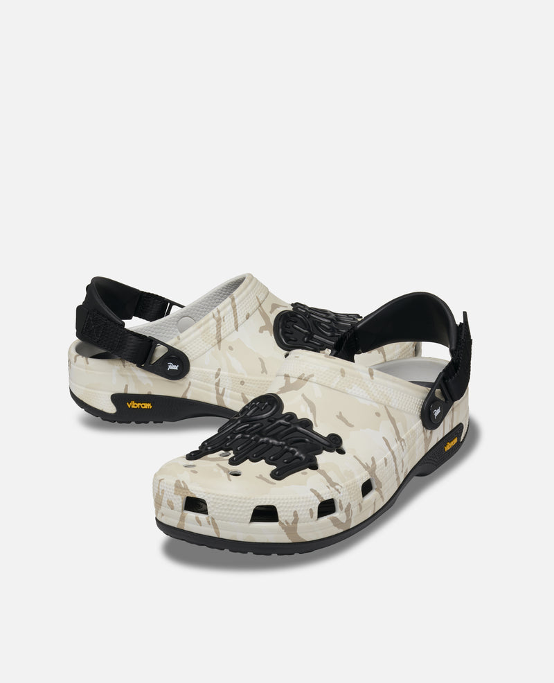 Patta x Crocs Classic EXP Clog White 212487-1CN hero image showing white Croslite upper Vibram Christy outsole and Patta Jibbitz charms