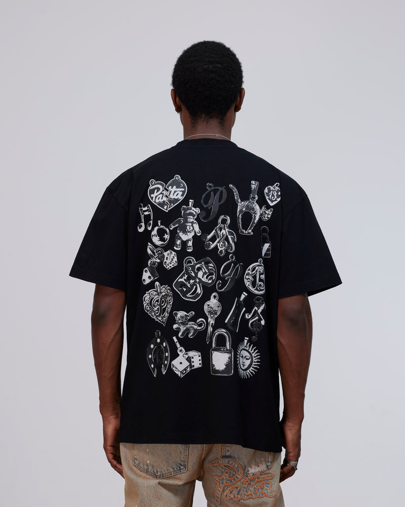 Back view of model wearing the black Patta Charm T-Shirt with white charms graphic print.