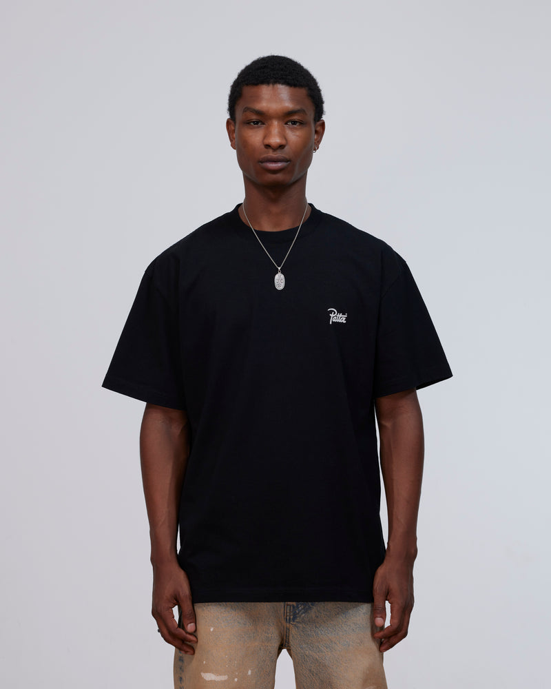 Front view of a model wearing the black Patta Charm cotton t-shirt with script logo on the chest.