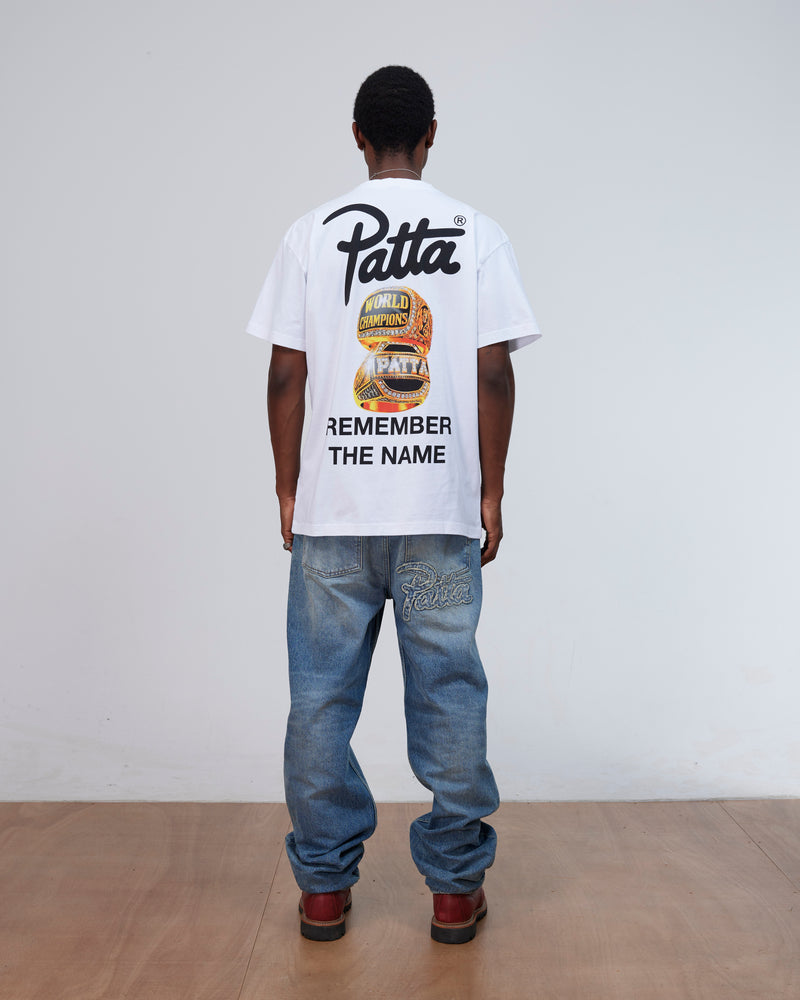 Back view of a model wearing the white Patta Championship T-Shirt with Remember The Name graphic.