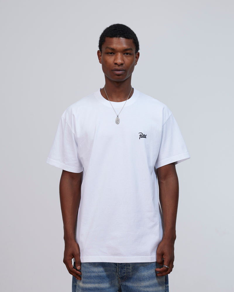 Model wearing the white Patta Championship T-shirt featuring a script logo on the chest.