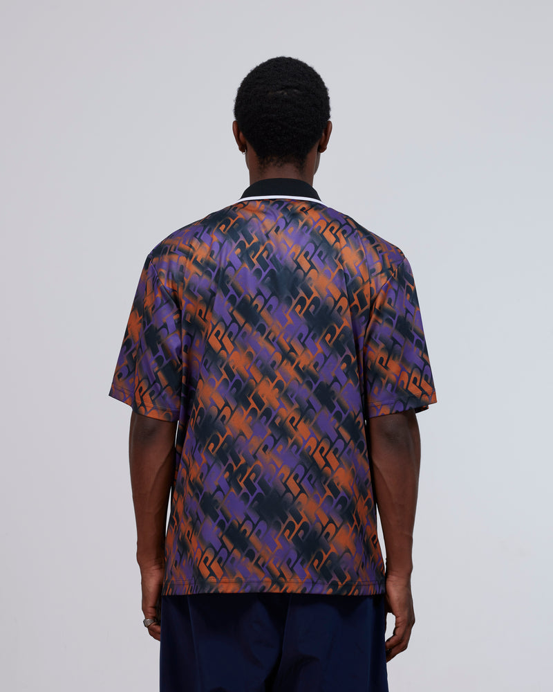 Back view of a model wearing the Patta All Over P Football Jersey in Pansy purple and orange.