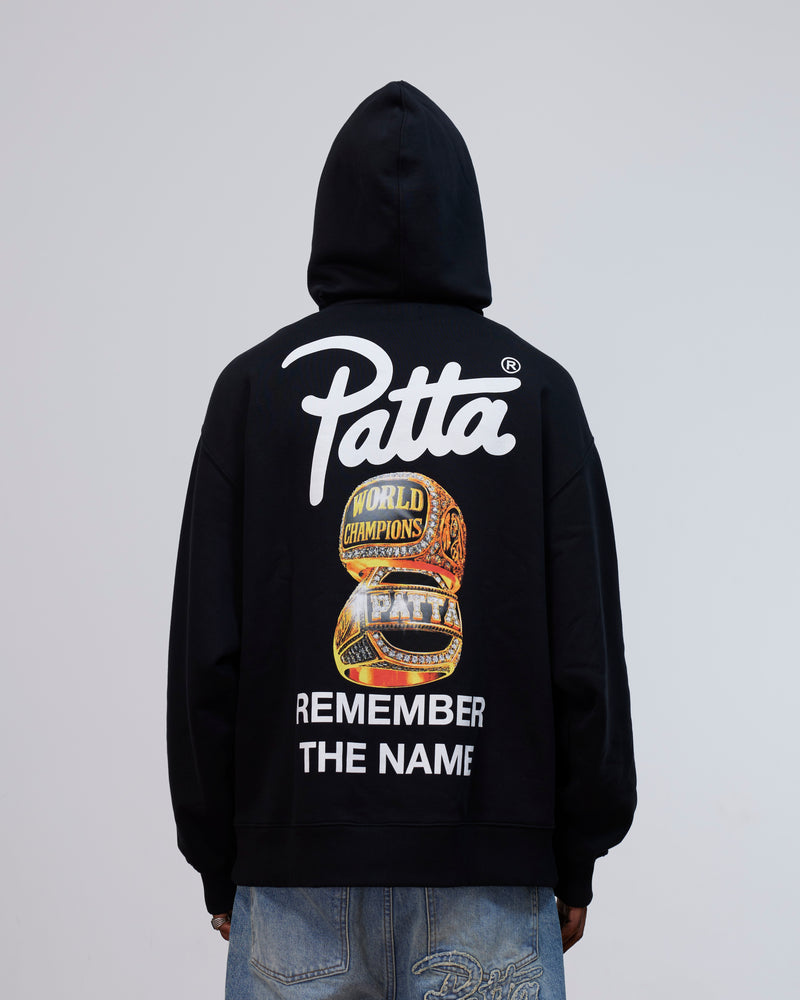 Back view of the Patta Kids Championship Hooded Sweater in black with rings graphic and logo print.
