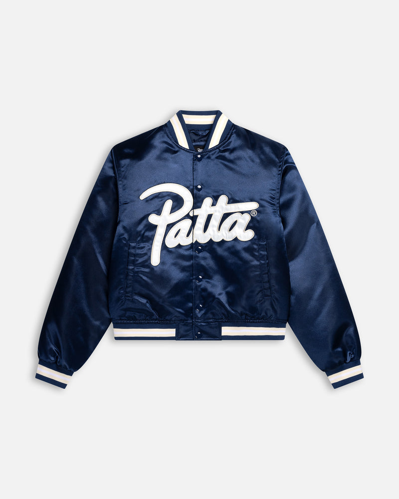 Patta Kids satin bomber jacket in Black Iris navy with a white script logo appliqué across the front.